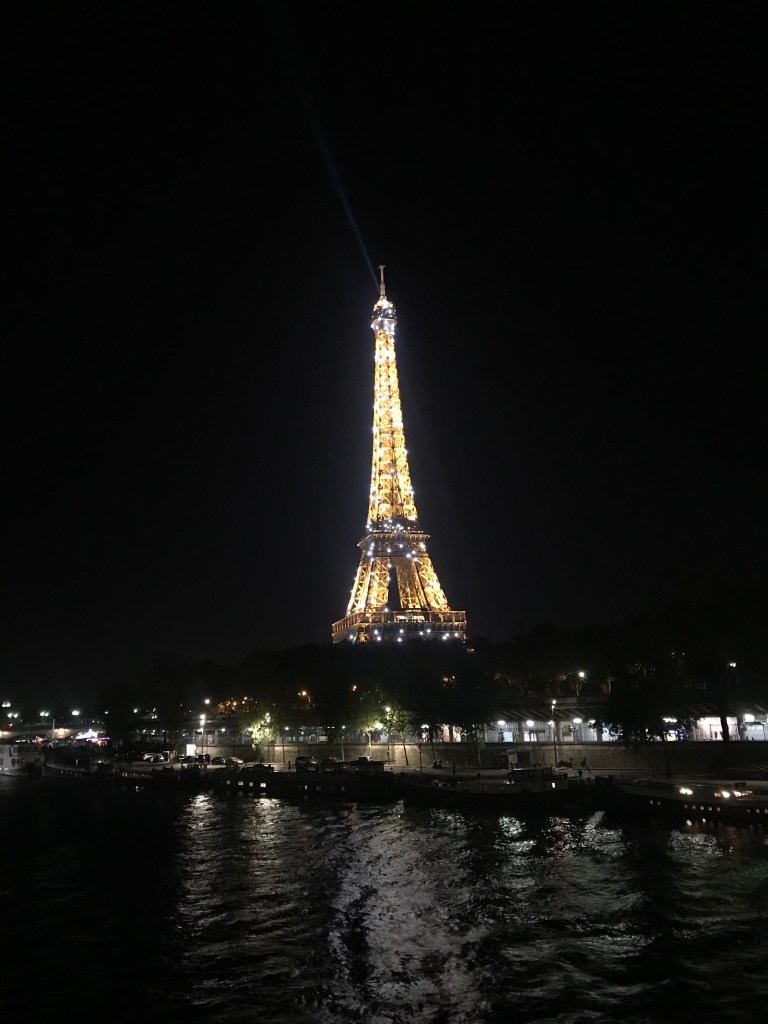 2 sparkly eiffel tower over river